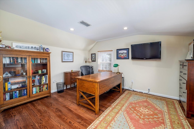 home office with vaulted ceiling, visible vents, baseboards, and wood finished floors