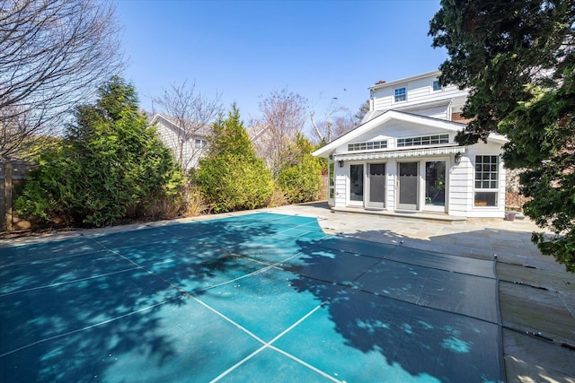 view of swimming pool featuring a covered pool and a patio area