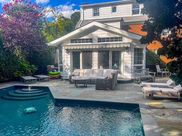 outdoor pool with a patio area and an outdoor living space