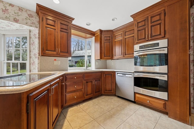 22 Druid Hill Rd, Port Jefferson, NY 11777 - kitchen featuring stainless steel appliances, a sink, wallpapered walls, light countertops, and light tile patterned floors