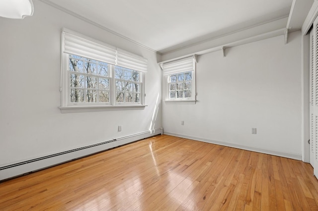 22 Druid Hill Rd, Port Jefferson, NY 11777 - spare room with a baseboard heating unit, ornamental molding, hardwood / wood-style flooring, and baseboards