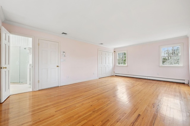 22 Druid Hill Rd, Port Jefferson, NY 11777 - unfurnished bedroom featuring crown molding, a baseboard radiator, light wood-style floors, baseboards, and connected bathroom