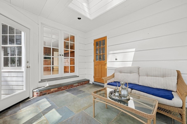 22 Druid Hill Rd, Port Jefferson, NY 11777 - living area with stone tile flooring and a skylight