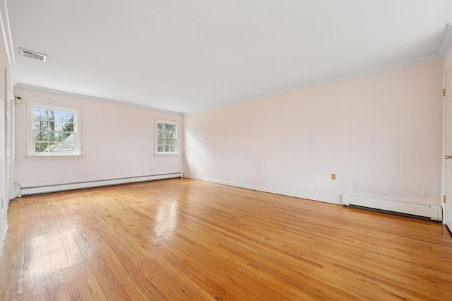 22 Druid Hill Rd, Port Jefferson, NY 11777 - spare room featuring a baseboard radiator, crown molding, healthy amount of natural light, and light wood-style flooring