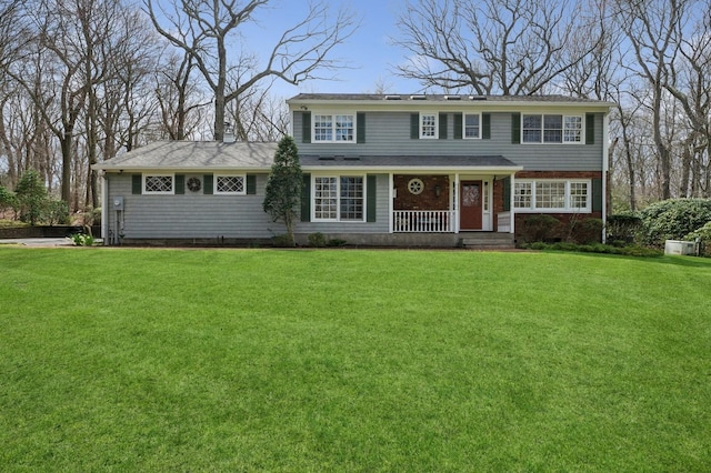 22 Druid Hill Rd, Port Jefferson, NY 11777 - view of front of house with a front yard, a porch, and brick siding