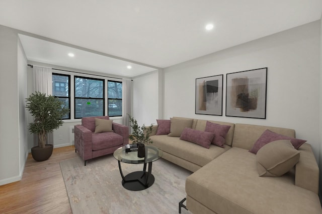 living area featuring recessed lighting, baseboards, and light wood-type flooring