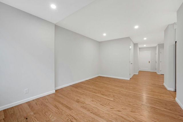 spare room with recessed lighting, baseboards, and light wood finished floors