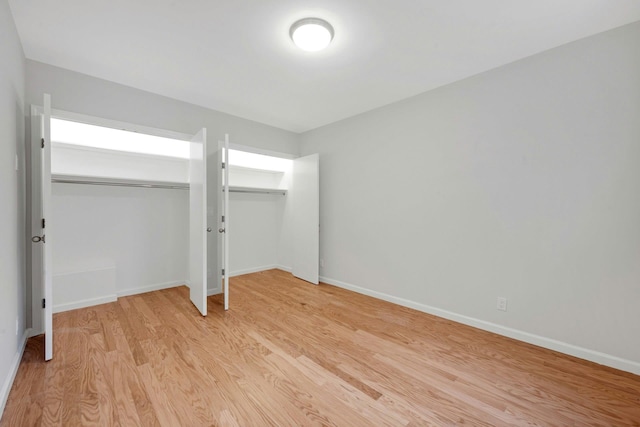 unfurnished bedroom with light wood-style floors and baseboards