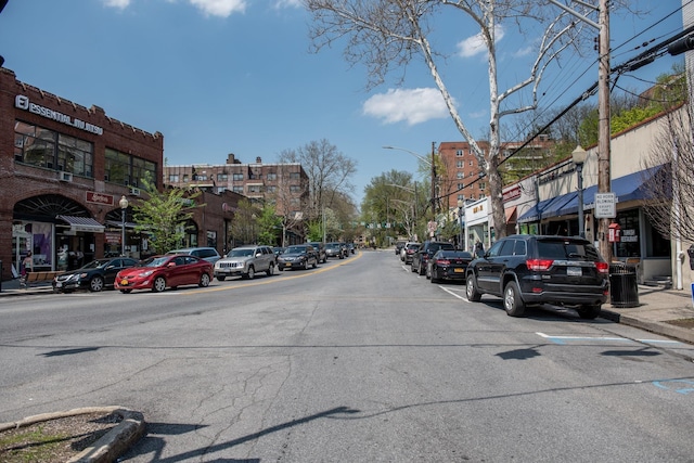 view of street featuring street lighting, curbs, and sidewalks
