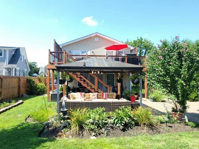 2892 Wilson Ave, Bellmore, NY 11710 - rear view of house with stairs, fence, a wooden deck, an outdoor living space, and a lawn