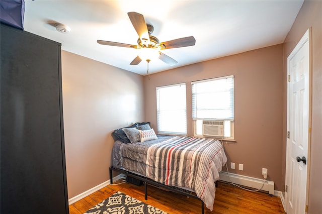 2892 Wilson Ave, Bellmore, NY 11710 - bedroom with baseboards, ceiling fan, wood finished floors, and baseboard heating