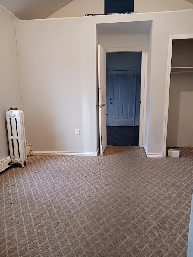 102-23 Russell St, Hamilton Beach, NY 11414 - unfurnished bedroom with a closet, baseboards, radiator, and carpet floors