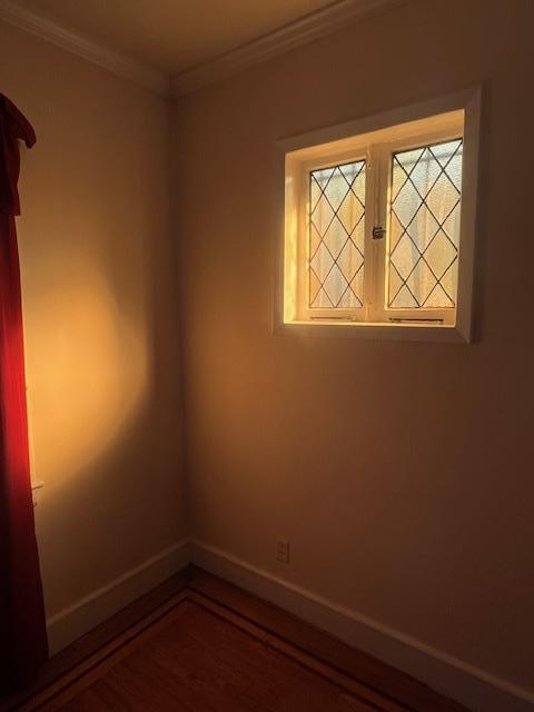1242 Pawnee Pl, Bronx, NY 10461 - spare room with ornamental molding, baseboards, and wood finished floors
