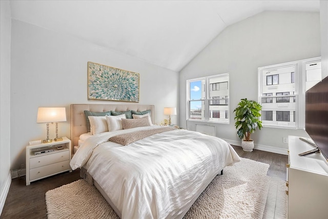 bedroom featuring baseboards, lofted ceiling, and dark wood finished floors