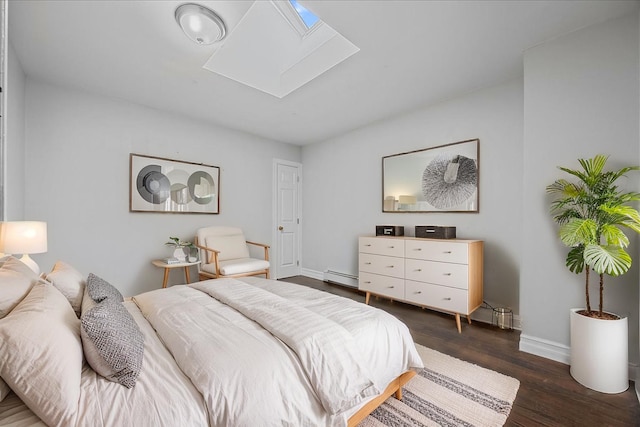 bedroom with a skylight, baseboards, a baseboard heating unit, and dark wood finished floors