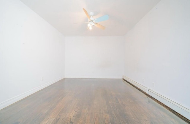 unfurnished room featuring baseboards, wood finished floors, a ceiling fan, and a baseboard radiator