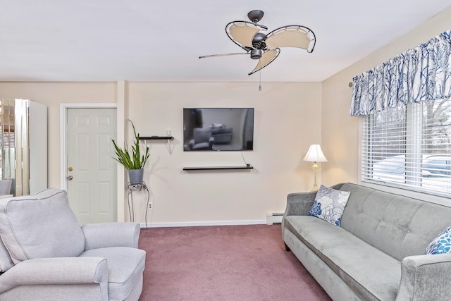 living area with baseboard heating, ceiling fan, baseboards, and carpet