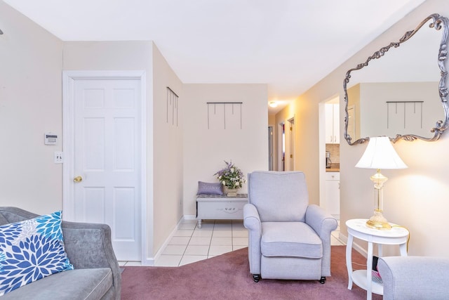 sitting room featuring tile patterned floors and baseboards