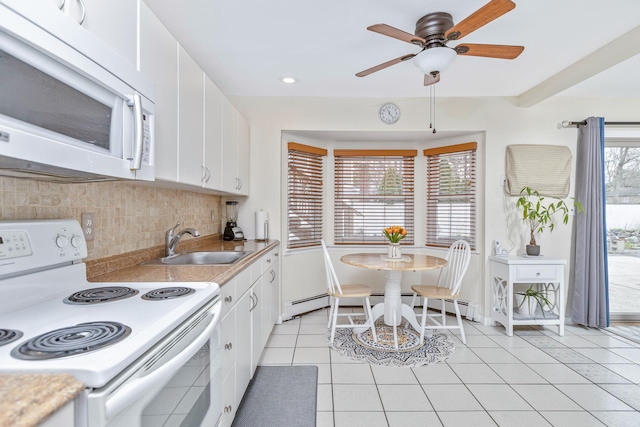 kitchen featuring white appliances, tasteful backsplash, white cabinetry, a sink, and light tile patterned floors