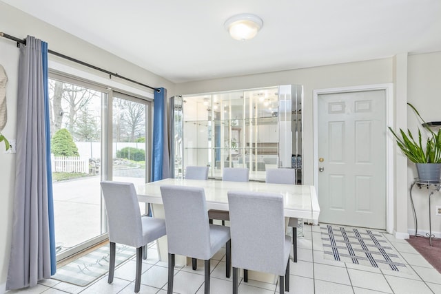dining room featuring light tile patterned flooring and baseboards