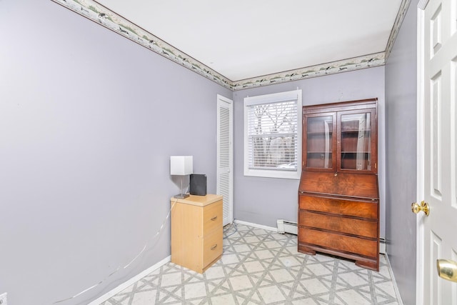 office area featuring baseboards, baseboard heating, a baseboard heating unit, and light floors