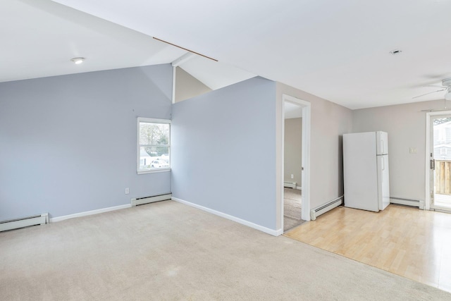 unfurnished room featuring a healthy amount of sunlight, a baseboard radiator, and a ceiling fan