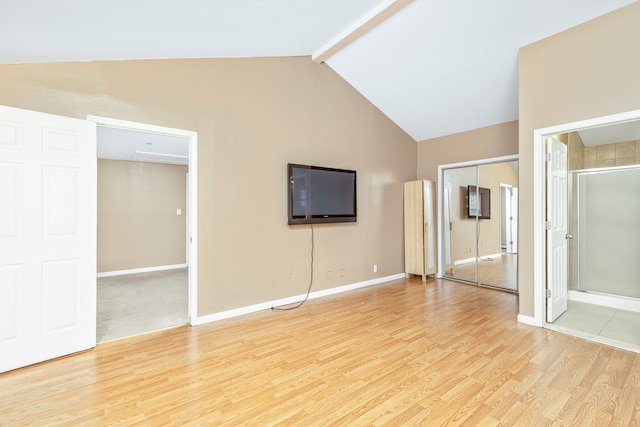 unfurnished bedroom featuring attic access, high vaulted ceiling, baseboards, beam ceiling, and light wood-style flooring
