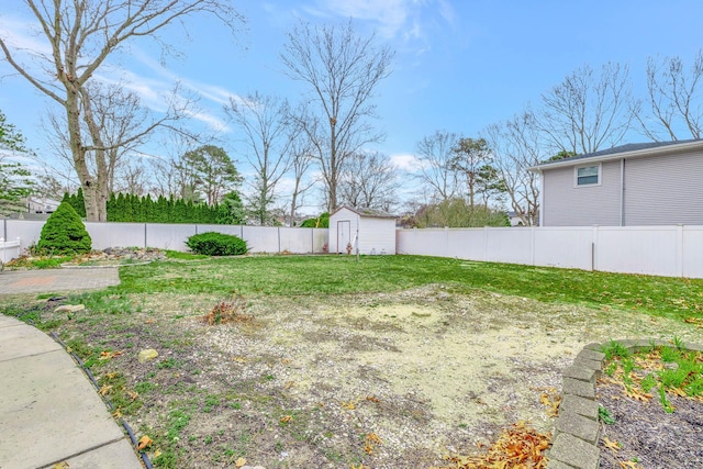 view of yard featuring a fenced backyard, a shed, and an outbuilding