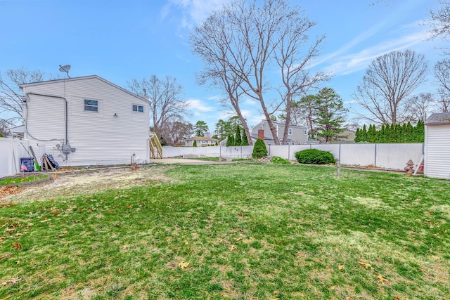view of yard featuring a fenced backyard and stairway
