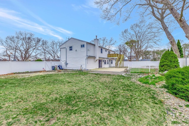 view of yard with a fenced backyard, stairway, and a patio