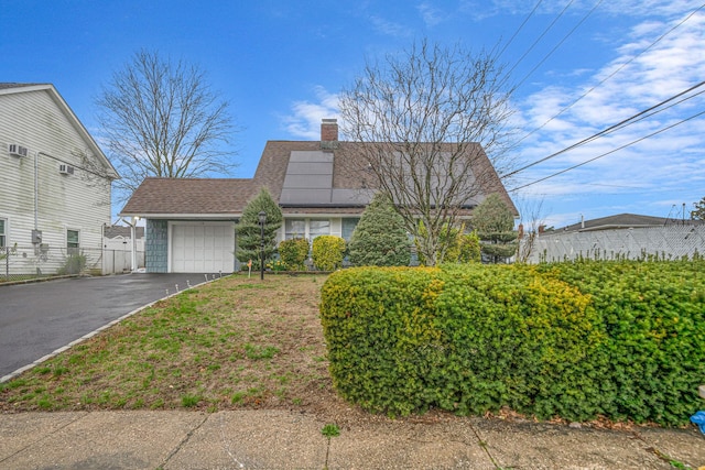 173 Bloomingdale Rd, Levittown, NY 11756 - view of front of home with a chimney, driveway, an attached garage, fence, and a shingled roof