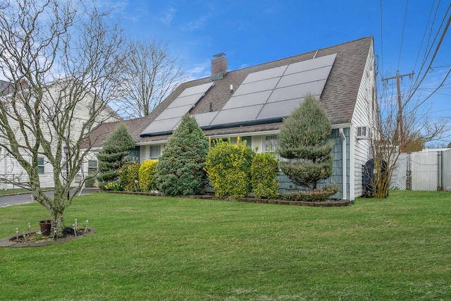 173 Bloomingdale Rd, Levittown, NY 11756 - exterior space featuring solar panels, a yard, a chimney, fence, and roof with shingles
