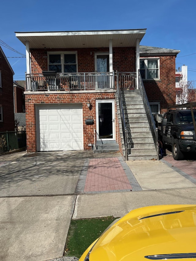 2443 Bouck Ave, Bronx, NY 10469 - view of front of home featuring driveway, brick siding, stairs, and an attached garage