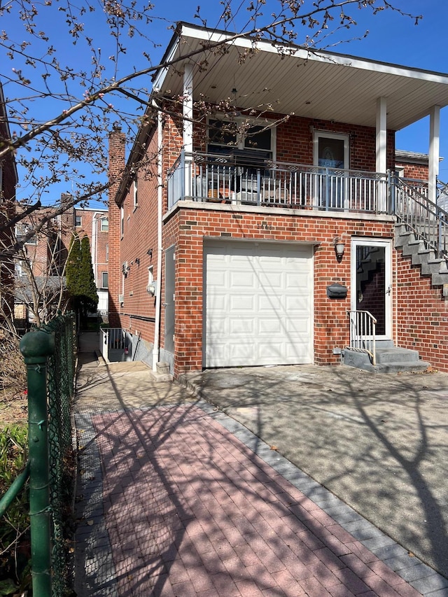 2443 Bouck Ave, Bronx, NY 10469 - view of front of house featuring an attached garage, central AC unit, concrete driveway, and brick siding