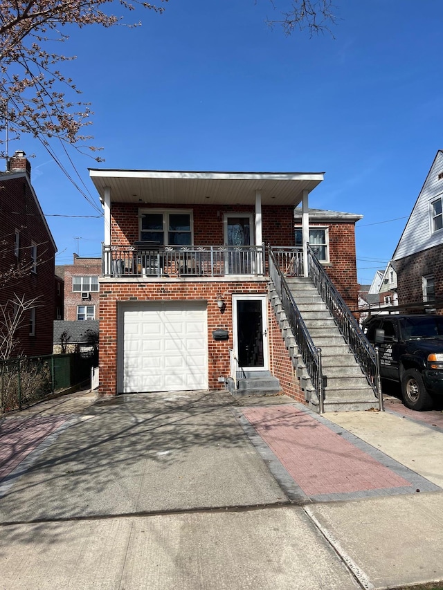 2443 Bouck Ave, Bronx, NY 10469 - view of front of property with brick siding, driveway, a garage, and stairway