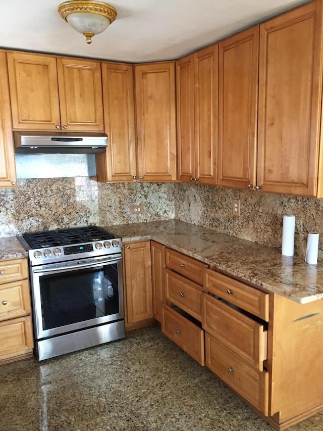 2443 Bouck Ave, Bronx, NY 10469 - kitchen with tasteful backsplash, stainless steel range with gas stovetop, under cabinet range hood, and brown cabinetry