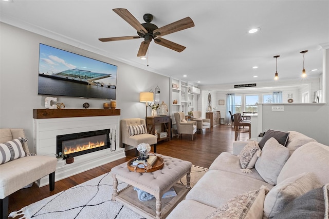 living room featuring recessed lighting, wood finished floors, a ceiling fan, and ornamental molding