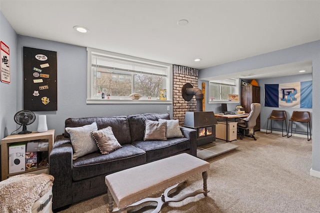 carpeted living room with recessed lighting and a wood stove