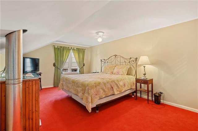 carpeted bedroom with baseboards and vaulted ceiling