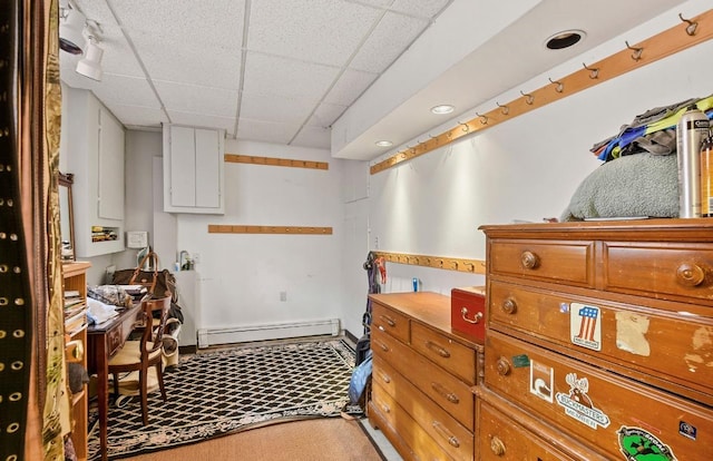 interior space with a baseboard heating unit, a paneled ceiling, recessed lighting, and light colored carpet