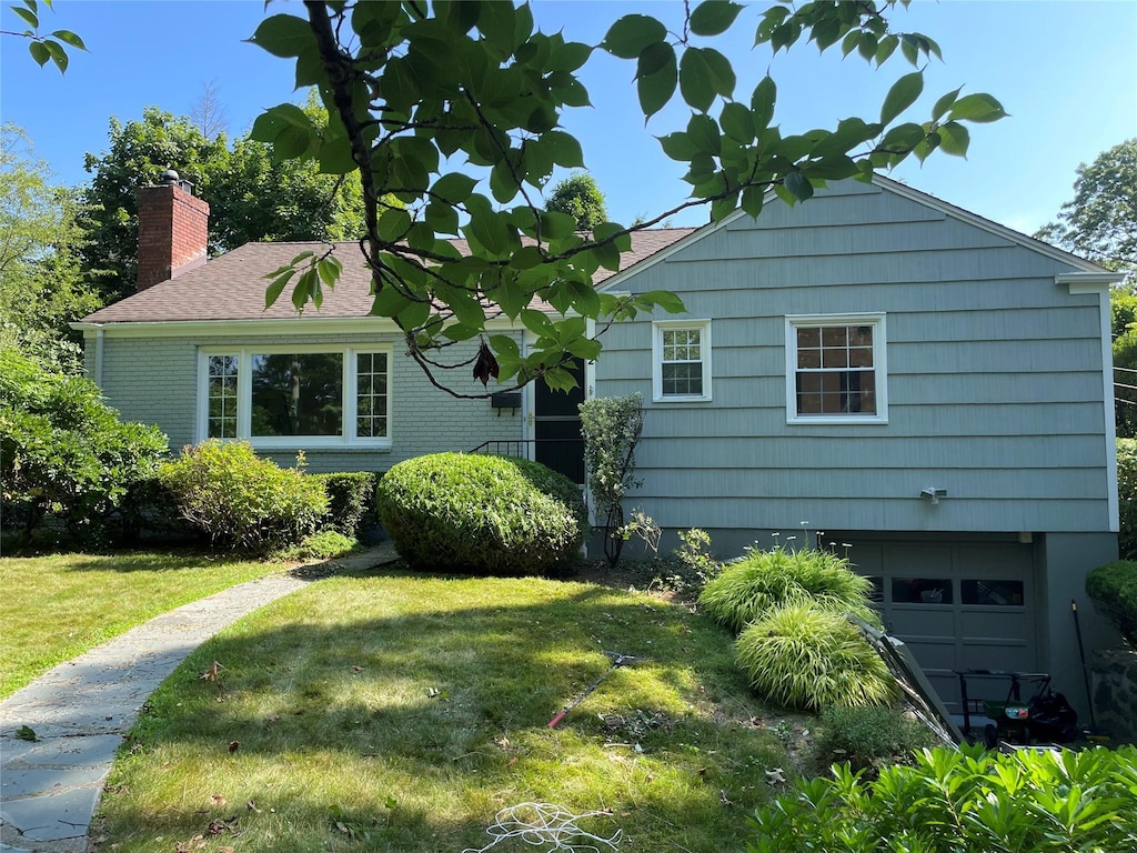 2 Forest Pl, Larchmont, NY 10538 - view of front of home with a garage, a front lawn, and a chimney