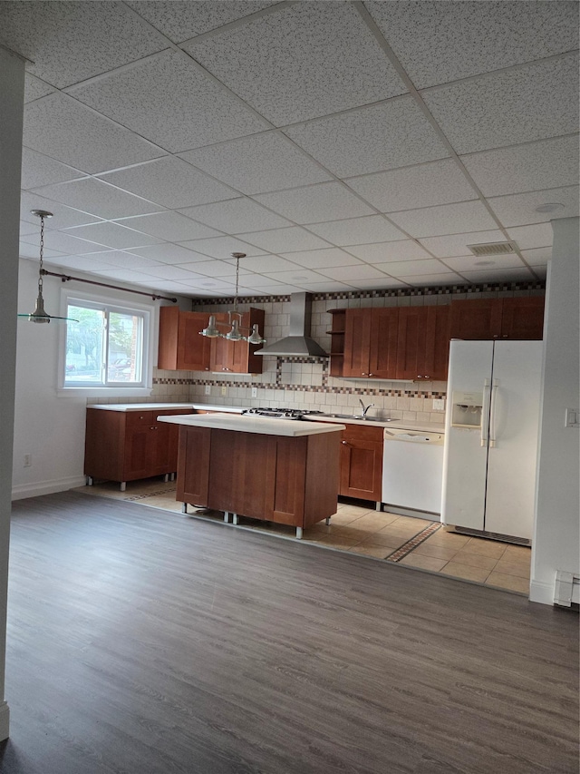 111 Washington St, Port Chester, NY 10573 - kitchen with white appliances, wall chimney exhaust hood, light countertops, light wood-type flooring, and a drop ceiling
