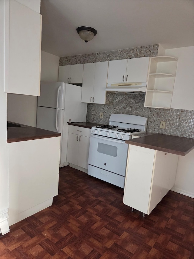 111 Washington St, Port Chester, NY 10573 - kitchen with white appliances, under cabinet range hood, dark countertops, and tasteful backsplash