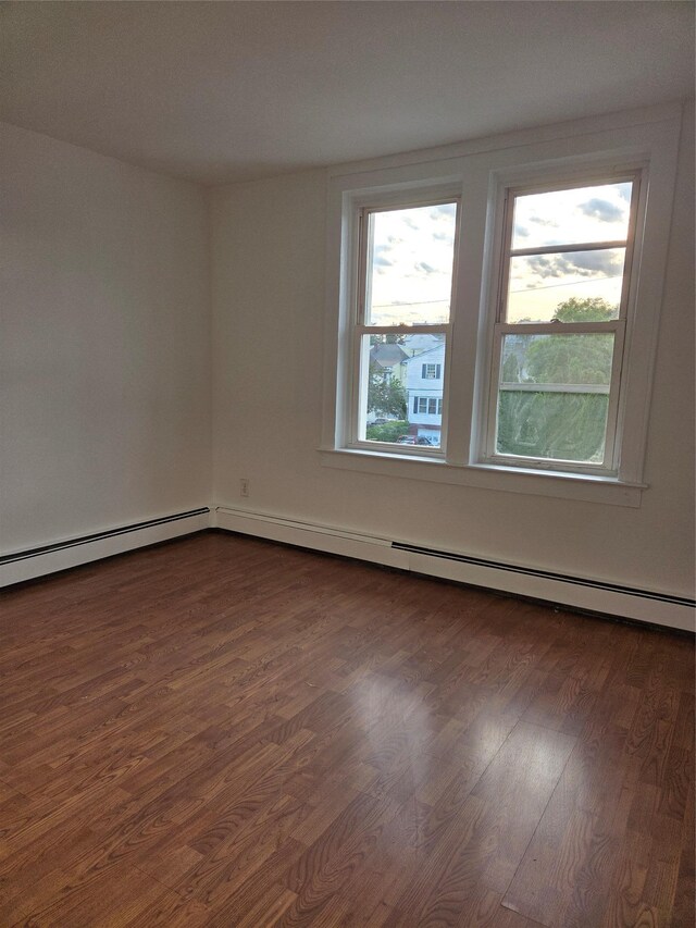 111 Washington St, Port Chester, NY 10573 - spare room with dark wood-type flooring and a baseboard radiator