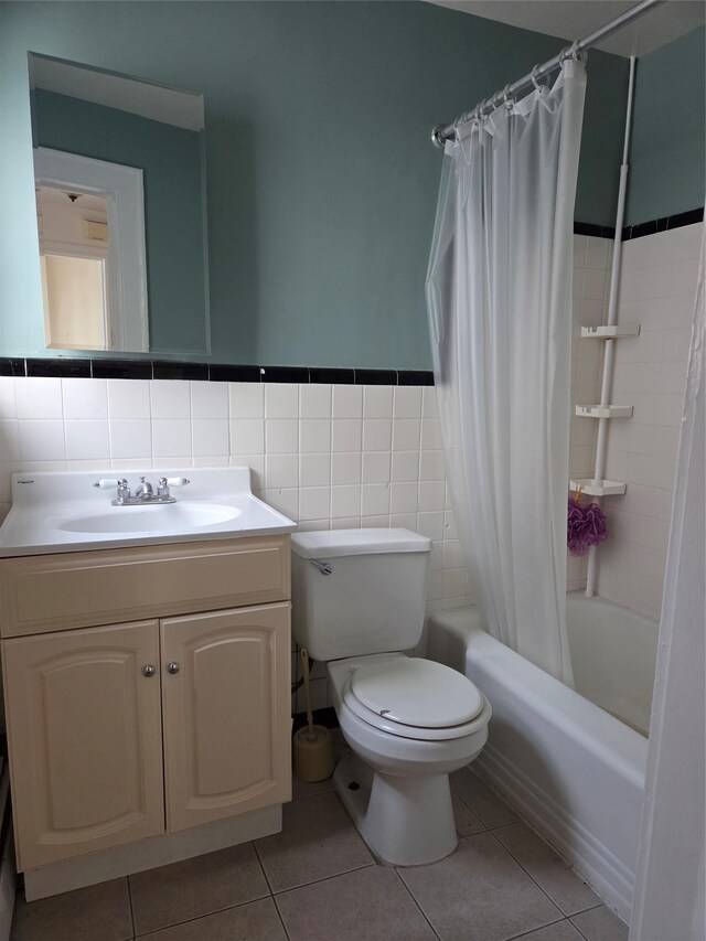 111 Washington St, Port Chester, NY 10573 - bathroom featuring shower / bath combo with shower curtain, toilet, vanity, tile patterned floors, and tile walls