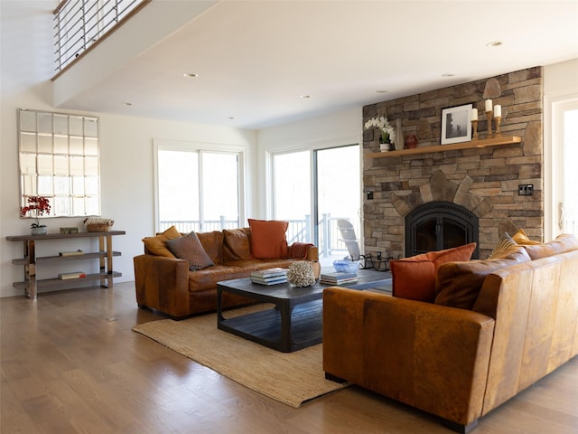 living room with wood finished floors, a fireplace, and recessed lighting