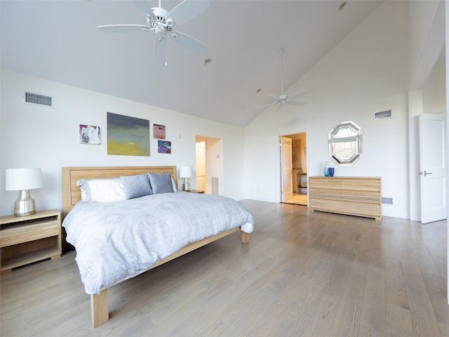bedroom featuring wood finished floors, high vaulted ceiling, a ceiling fan, and visible vents