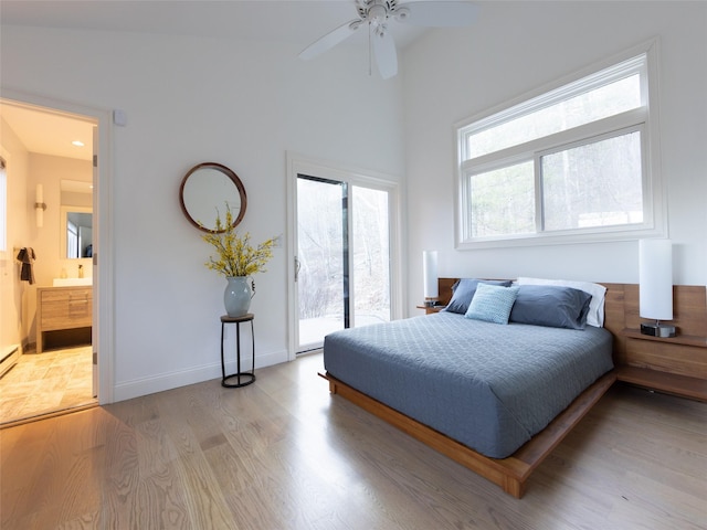 bedroom with access to outside, ensuite bathroom, light wood-style flooring, a ceiling fan, and baseboards