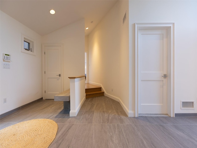 hallway featuring visible vents, baseboards, recessed lighting, and vaulted ceiling