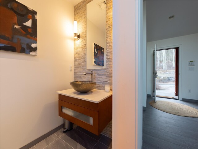 bathroom featuring tile patterned floors, vanity, and baseboards